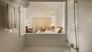 A modern bathroom with a large mirror, a bathtub, and a shower. - Gala Hotel (Taipei)