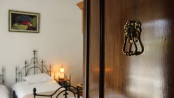 A wooden door with a brass handle and a framed picture on the wall.
