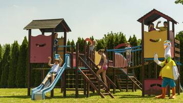 A playground with multiple slides and climbing structures.