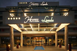 A hotel entrance with a large sign reading "HOTEL Livada" and a star rating of five stars. - Hotel Livada Prestige - Sava Hotels & Resorts (Moravske Toplice)