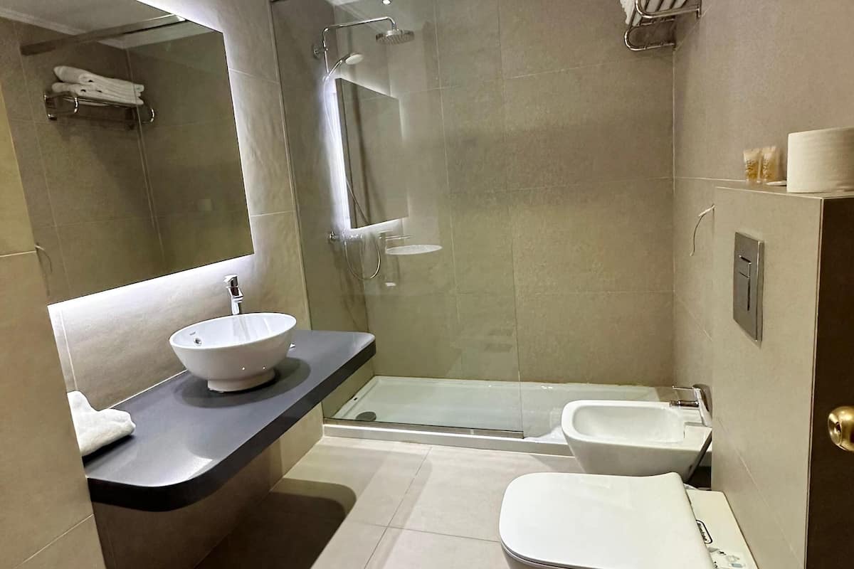 junior suite | bathroom | hair dryer, slippers, bidet, towels