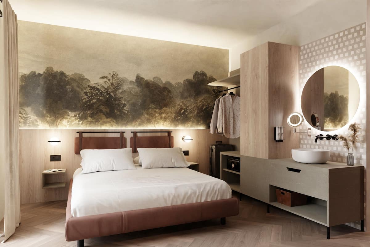 Un dormitorio moderno con una cama grande, un tocador con espejo redondo y un mural en la pared.