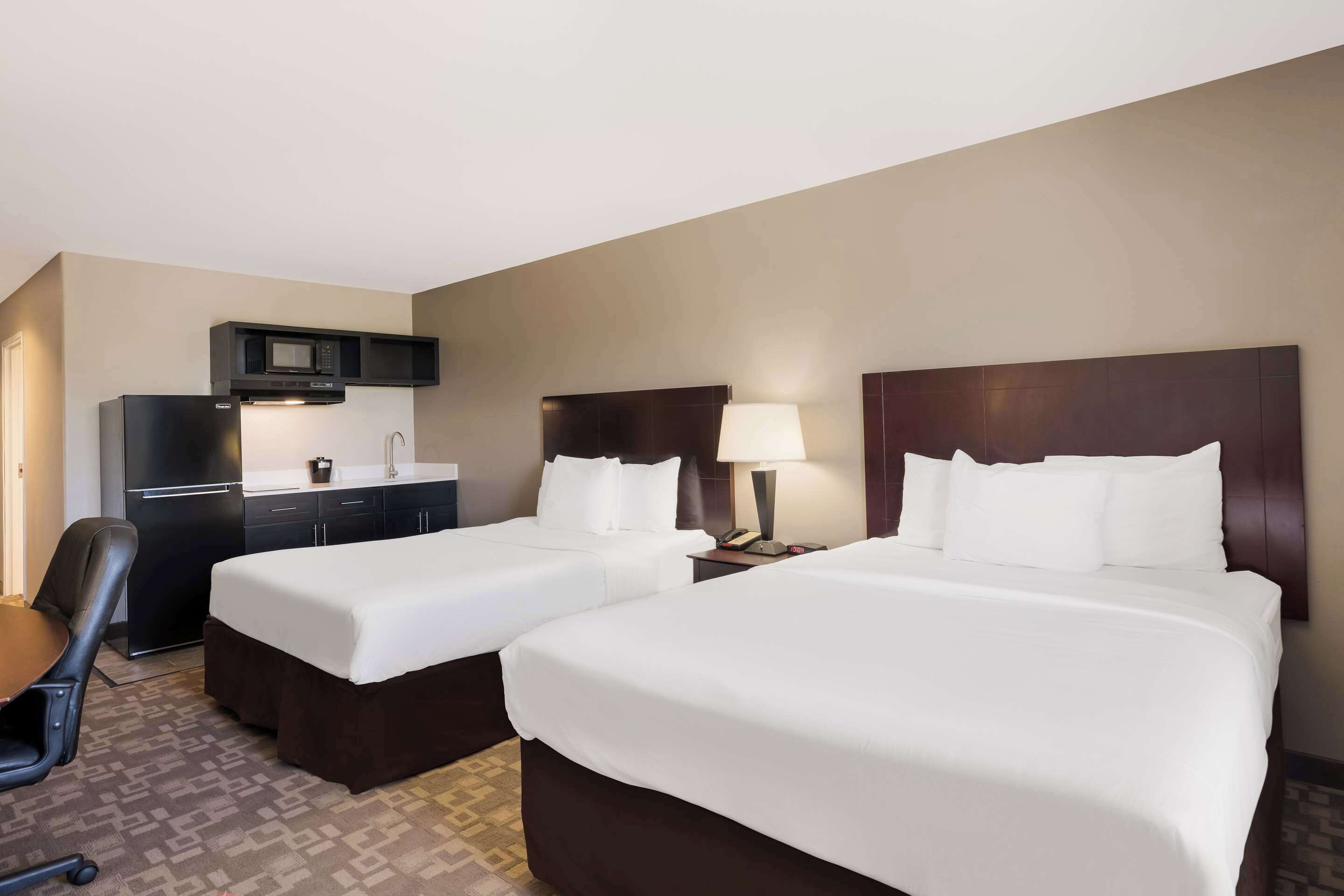 suite, 2 queen beds, non smoking, kitchenette | individually furnished, desk, laptop workspace, iron/ironing board