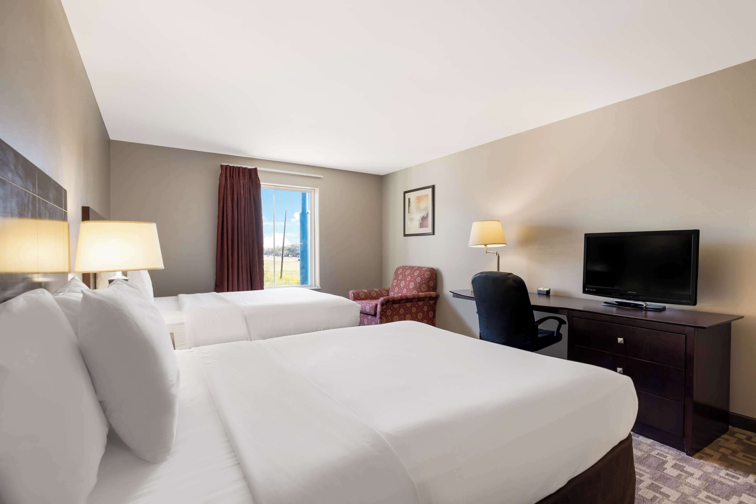 suite, 2 queen beds, non smoking, kitchenette | individually furnished, desk, laptop workspace, iron/ironing board