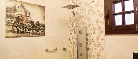 A bathroom with a vintage car illustration, a shower with multiple nozzles, and a patterned tile design.
