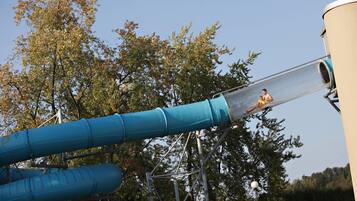 A water slide with a person sliding down.