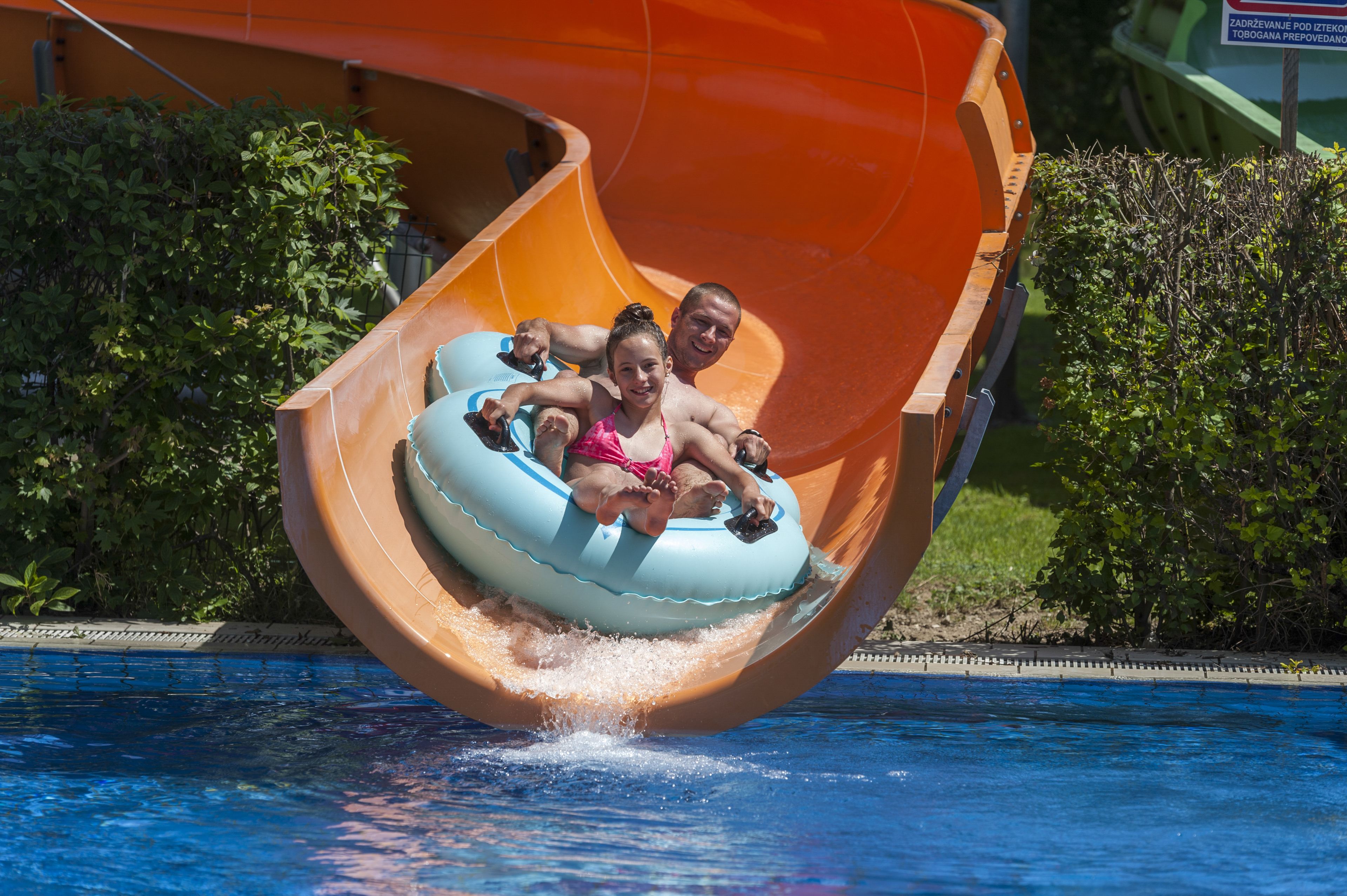 A water slide with a tube carrying two people.