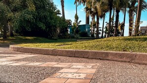 A tiled pathway with footprints and the name "DAVID LYNCH" engraved on the tiles. - Hotel Anna Livia (Cannes)