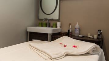Experience a clean and welcoming space with a neatly made bed, a bathroom with a sink and mirror, and a focus on hygiene and comfort.