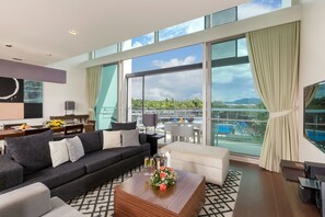 Suite, 2 Bedrooms | Living area | 33-inch LCD TV with cable channels, TV, DVD player
