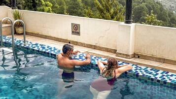 Outdoor pool, open 8:30 AM to 7 PM, pool umbrellas, pool loungers