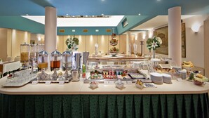 A buffet setup with various food items and beverages. - Hotel Central (Zagreb)
