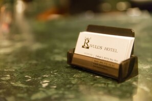 A business card holder with a card for RIVULUS HOTEL.