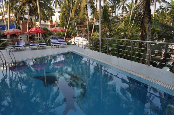Outdoor pool, open 6:30 AM to 6:30 PM, pool umbrellas, pool loungers