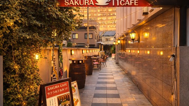 A cafe named 'SAKURA CAFE' with outdoor seating, a checkered floor, and a signboard. - Sakura Hotel Hatagaya (Tokyo)