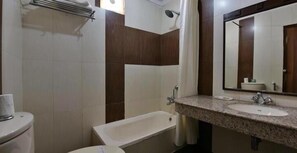 Bathroom features a white toilet, bathtub, and granite sink with a mirror.