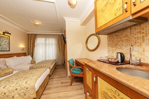 A hotel room with a bed, a desk, a chair, a sink, and a mirror. - Santa Ottoman Hotel (Istanbul)