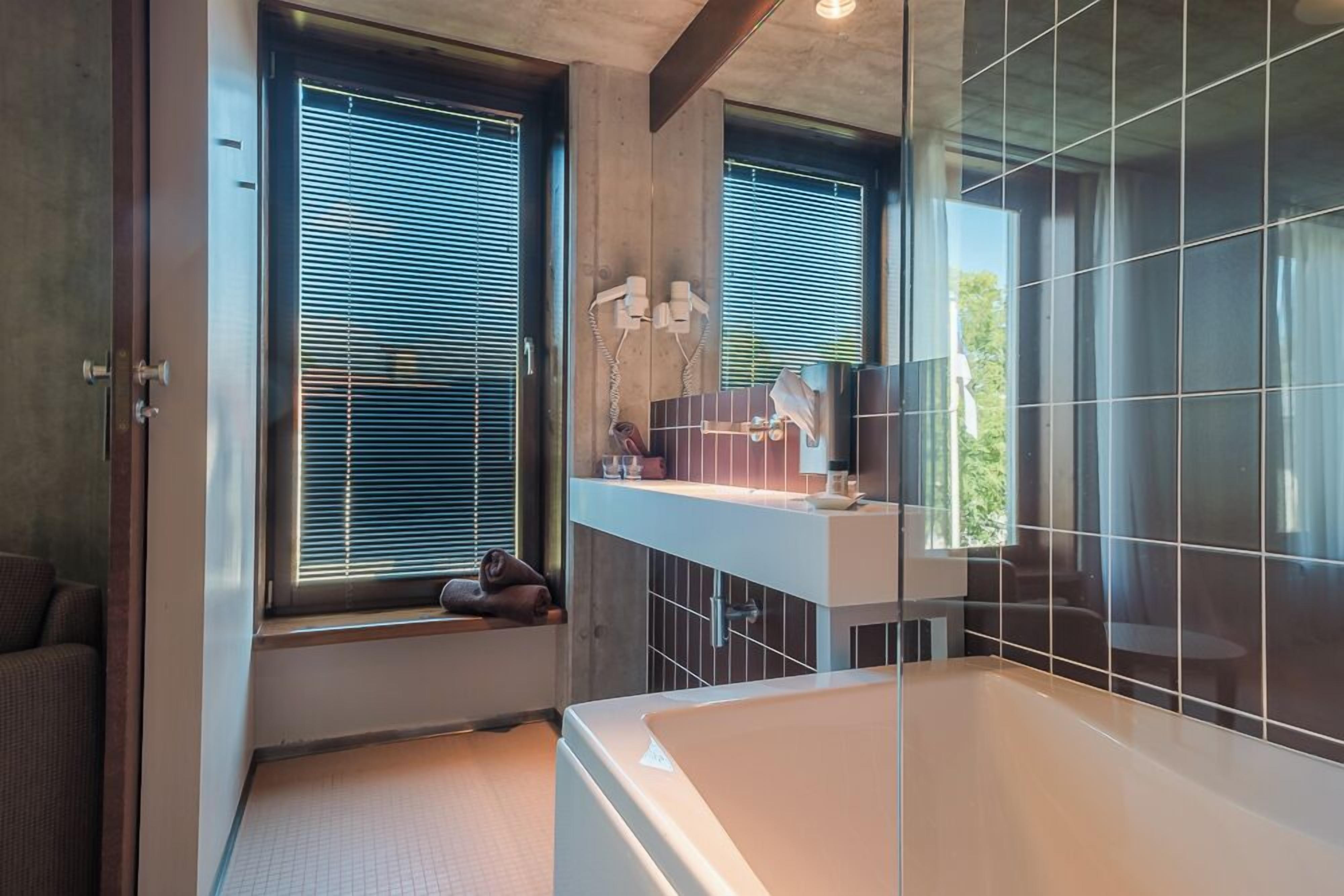junior suite, bathtub (spa access included) | bathroom amenities | free toiletries, hair dryer, bathrobes, slippers