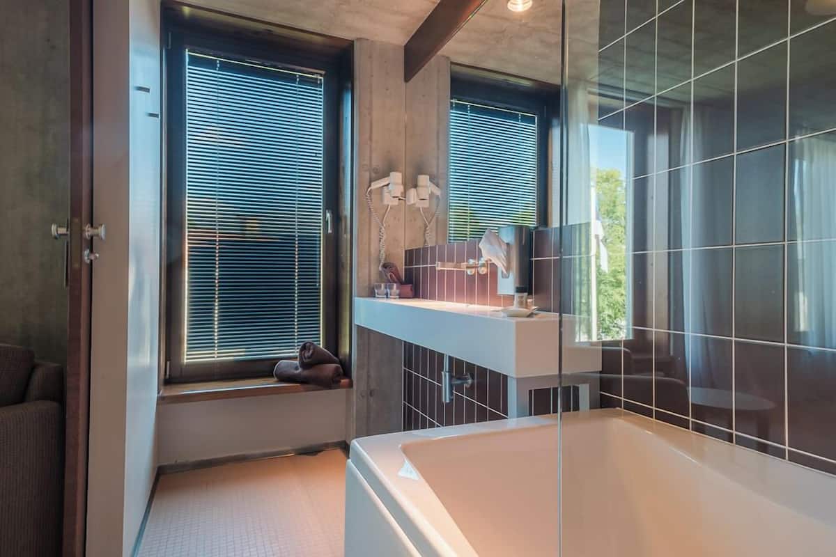 junior suite, bathtub (spa access included) | bathroom amenities | free toiletries, hair dryer, bathrobes, slippers