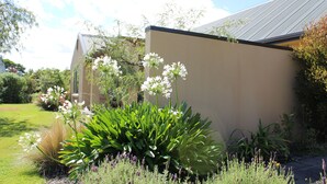 A modern building with a flat roof and a beige exterior wall. - Vintner's Retreat (Rapaura)