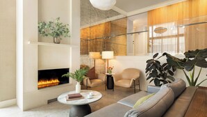 A modern living room with a fireplace, comfortable seating, and large windows. - Hotel Veritas (Cambridge)