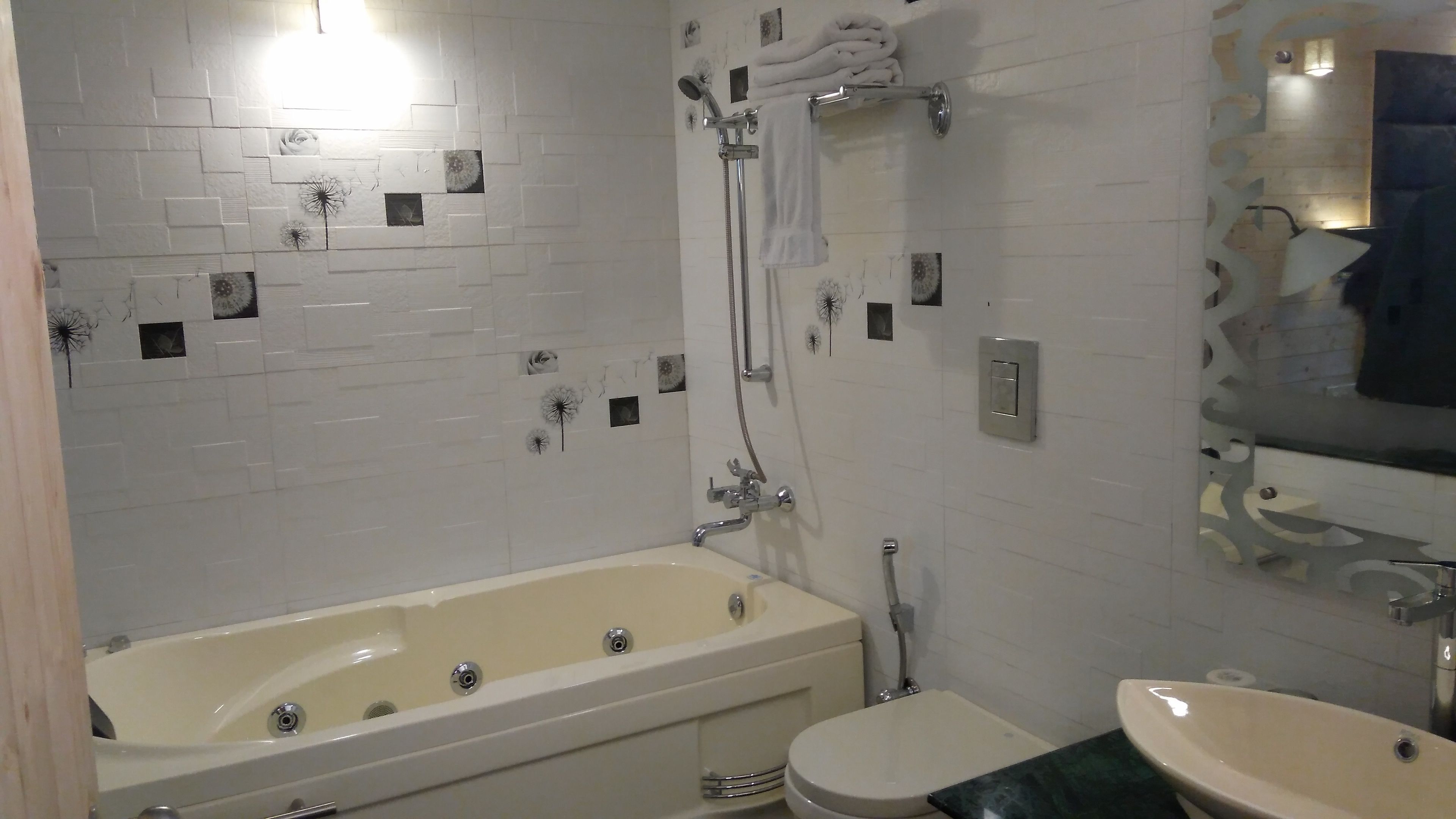 A bathroom with a bathtub, toilet, and sink.