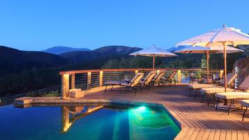 Relax by the pool surrounded by a wooden deck and take in the breathtaking views of the mountains.