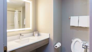 A bathroom with a sink, mirror, towel rack, and toilet.