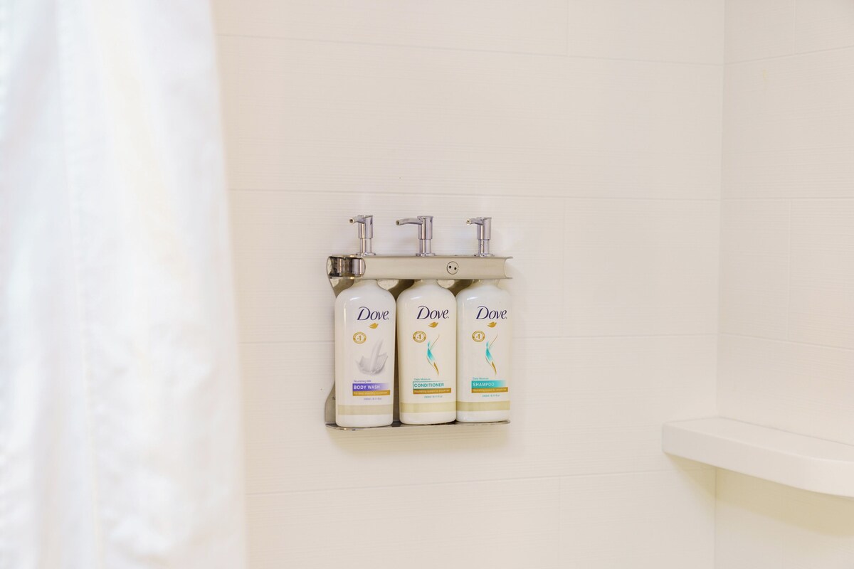Three Dove personal care products on a bathroom shelf.