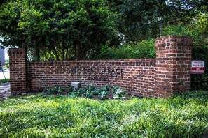 A brick wall with the text "WILLIAM BEAUX UNIVERSITY" and a sign indicating "PRIVATE PROPERTY NO TRESPASSING".