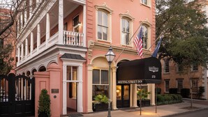 A historic building with a balcony, a black mailbox, and an American flag. - The Meeting Street Inn (Charleston)