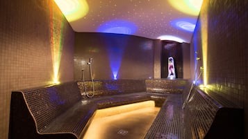 Relax in a serene spa area with a curved design, featuring a central seating area, bench, and hot tub.