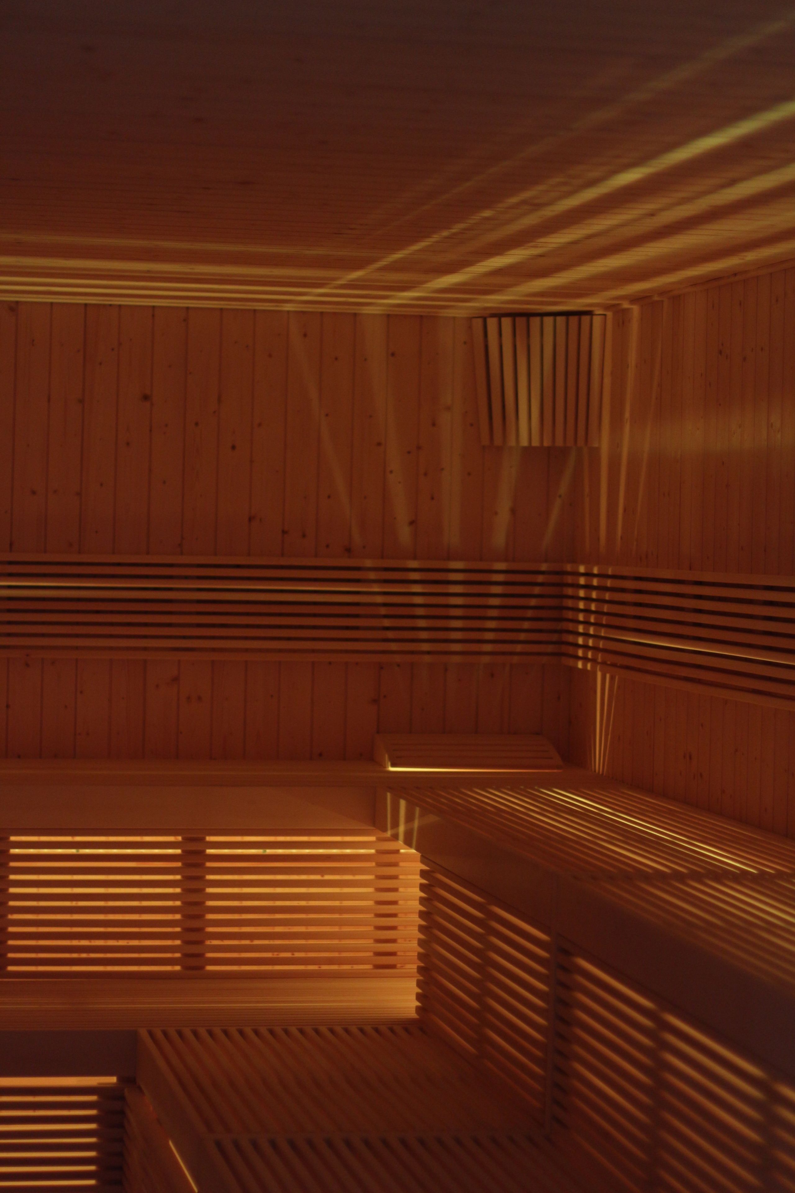 A sauna with wooden slats and benches.