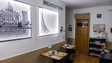 A breakfast room with tables, chairs, and a wall-mounted clock.