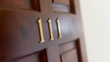 A close-up of a wooden door with the number 111.