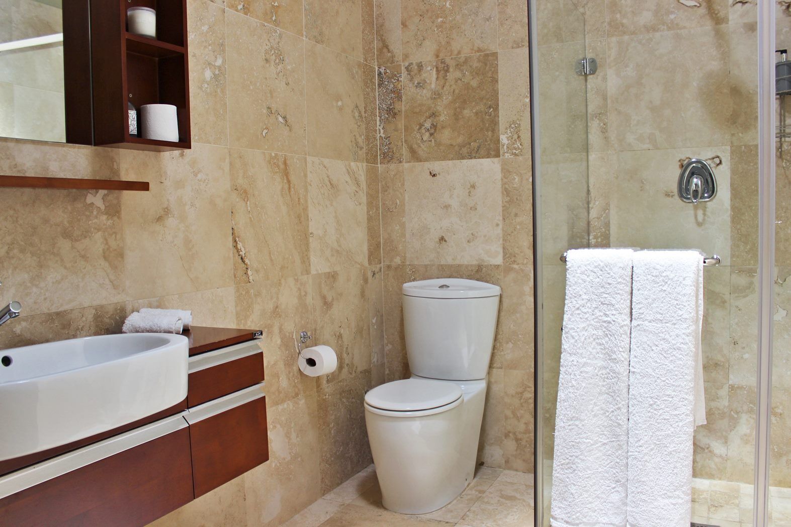A bathroom with a bathtub, toilet, and shower.