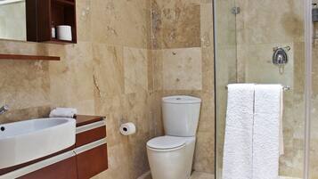 A bathroom with a bathtub, toilet, and shower.