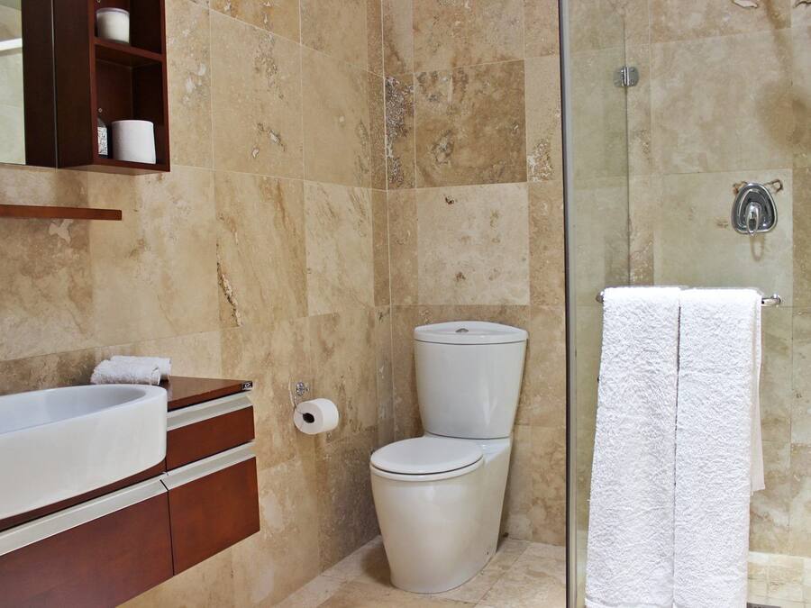 A bathroom with a bathtub, toilet, and shower.