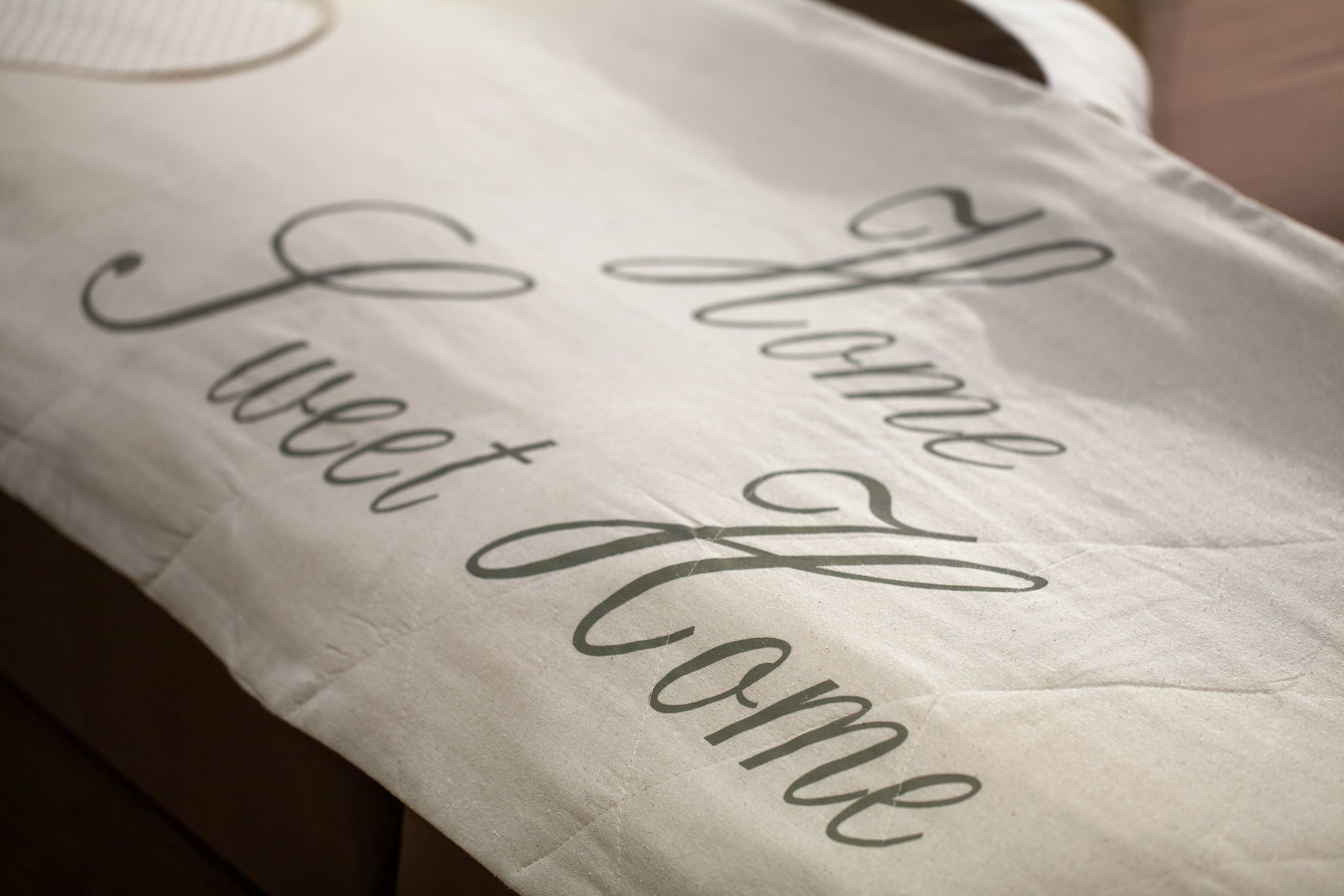 A pillow with the text "Home Sweet Home" embroidered on it.