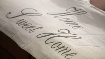 A pillow with the text "Home Sweet Home" embroidered on it.
