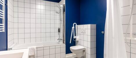 A modern bathroom with a bathtub, shower, and toilet.