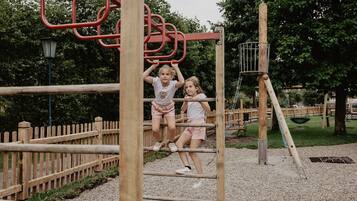 Children can climb and play on this playground structure with interconnected bars and beams.