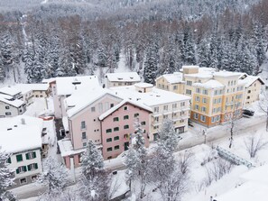 Set amidst a serene forest, this residential area offers a mix of traditional and modern homes with flat and pitched roofs.