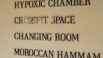 A wall with room names including Fitness Studio, Hypoxic Chamber, CrossFit Space, Changing Room, Moroccan Hammam, and Relaxation Lounge.