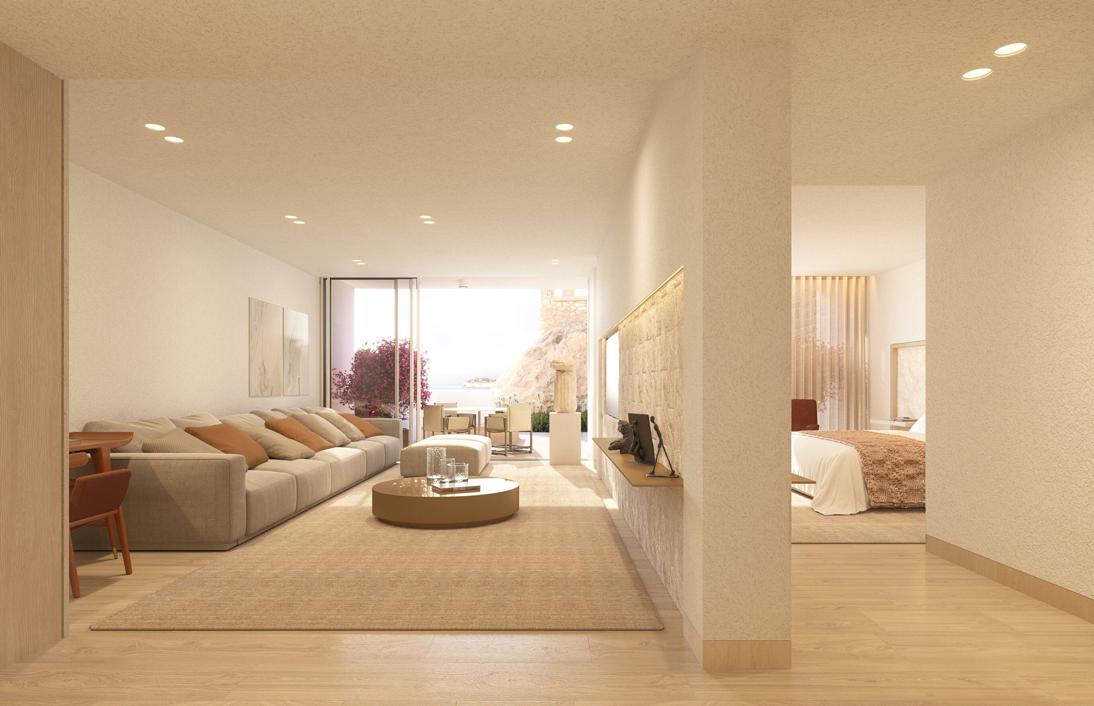 A modern living room with a sofa, coffee table, and a view of the outdoors.