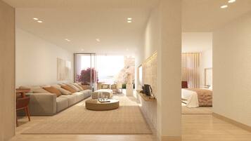 A modern living room with a sofa, coffee table, and a view of the outdoors.