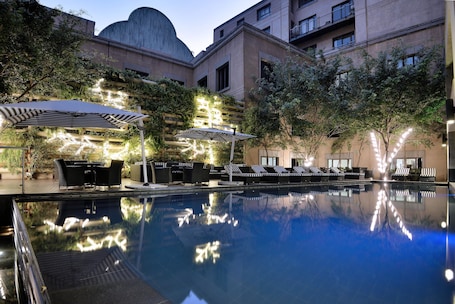 Outdoor pool, pool umbrellas, sun loungers. Davinci Hotel And Suites On Nelson Mandela Square