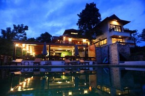 A modern hotel with a pool, outdoor seating, and a two-story structure. - Phunacome Resort (Dan Sai)