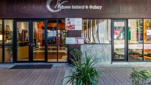 A wellness retreat & gallery with glass doors, indoor plants, and a wooden deck outside. - Nai Yang Beach Resort & Spa (Sa Khu)