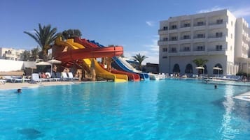 Enjoy a refreshing swim in the resort's pool, surrounded by lounge chairs and umbrellas, and take a thrilling ride down the multi-lane water slide.